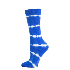 Blue and white tie-dye sock on a wooden block with a white background