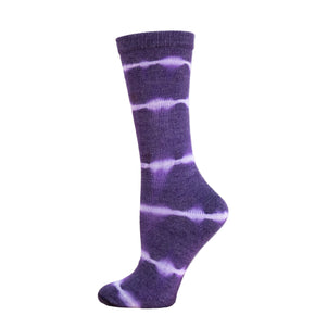 Purple tie-dye sock on a wooden block with a white background